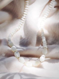 This white mother of pearl pikake shell necklace evokes visions of Hawaii's flower leis and reflect Hawaii's natural abundance. This unique beauty is ready for you and your tropical escape. ✦ DETAILS ✦✧ Name: Mau loa (maow LOah) - always and forever.✧ White Mother of Pearl beads.✧ 14kt Gold Filled clasp and beads.✧ All Ke Aloha Jewelry pieces come packaged thoughtfully, beautifully, and ready for gift giving. White Spiritual Shell Necklace As A Gift, White Spiritual Shell Necklace, Spiritual White Shell Necklace Gift, Mother Of Pearl Shell-shaped Necklace In Pearl White, Pearl White Mother Of Pearl Shell-shaped Necklace, White Adjustable Shell Necklace Spiritual Style, Delicate White Mother Of Pearl Jewelry, White Adjustable Spiritual Shell Necklace, White Adjustable Shell Necklace For Spiritual Wear