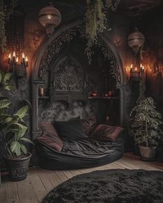 a bed with lots of pillows and plants in the corner next to it is lit by candles