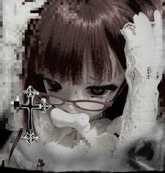 a girl with glasses and a cross on her shoulder is looking at the camera while holding her hand up to her face