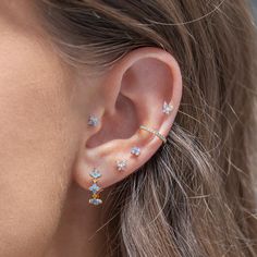 a woman's ear with three small stars on it