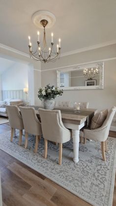 a dining room table with chairs and a chandelier