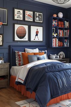 a bedroom decorated in blue and orange with basketball pictures on the wall above the bed