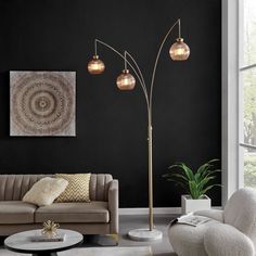 a living room with black walls and white furniture