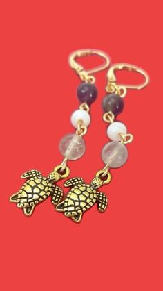 Sea Turtle dangle drop earrings with purple, green, white beads connected with gold finishings. Purple Dangle Jewelry For Beach, The Little Mermaid Ariel, Bead Earring, Little Mermaid Ariel, Jewelry Purple, Summer Ocean, Earring Handmade, Turtle Earrings, Marine Animals