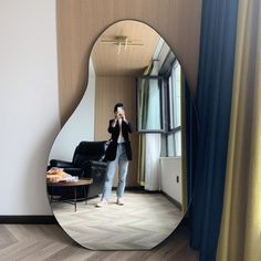 a woman taking a selfie in front of a mirror