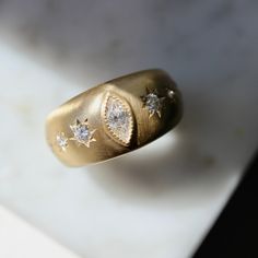 a gold ring with three diamonds on it