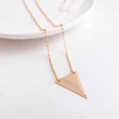 Gold Triangle Necklace - Gold Geometric Pendant - Delicate Necklace - Minimal Necklace - Minimalist Jewelry - Layering Necklace - Classic - Made to order at the length you choose - Delicate High quality 14K gold fill Chain with triangle shaped pendant. - The triangle charm is flat & light wight. It's also made of gold fill. - Beautiful on its own or layered with other necklaces. - This product comes in a gift box with the brand's logo and you can ask for gift wrap too (see picture). Color's Minimalist Rose Gold Metal Charm Necklaces, Minimalist Metal Clavicle Chain Charm Necklace, Minimalist Triangle Metal Necklace, Minimalist Rose Gold Chain Necklace, Gold Minimalist Chain Necklace, Minimalist Triangle-shaped Jewelry For Gifts, Gold Minimalist Chain Necklace With Simple Design, Minimalist Pendant Chain Necklace, Minimalist Metal Charm Necklaces With Delicate Chain