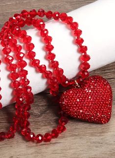 Elegant Red Rhinestone Heart Necklace With Black Fasted Beads to Add a Touch Of Sparkle Length: 32" Luxury Red Dazzling Necklace, Valentine's Day Beaded Party Necklace, Heart-shaped Beaded Crystal Necklace For Gift, Red Rhinestone Party Necklaces, Heart-shaped Rhinestone Necklaces For Party, Party Crystal Rhinestone Heart Pendant Necklace, Party Heart Pendant Beaded Necklace, Heart Shaped Rhinestone Party Necklace, Red Round Beaded Necklaces For Valentine's Day