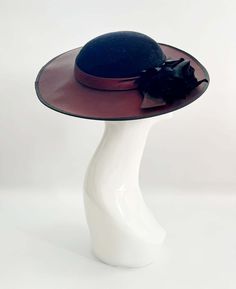 "Classic vintage hat. Perfect for Ascot, weddings, special occasions, very elegant. Comes with elastic to hold hat in place. Condition: vintage perfect Colour: black and dark burgundy Label: Made in England Material: polyester Size: M inner circumference aprox. 21.5-22 inches, circumference 44\"\" *Please note all hats come securely packed in a box *All our vintage items come in clean and best condition possible *Please note all hats come securely packed in a box *All our vintage items are top q Adjustable Wide Brim Felt Hat For Evening, Classic Evening Felt Hat For Kentucky Derby, Classic Felt Hat For Kentucky Derby Evening, Classic Kentucky Derby Evening Felt Hat, Elegant Wide Brim Felt Hat For Kentucky Derby, Classic Boater Hat With Short Brim For Evening, Classic Wide Brim Felt Hat For Evening, Classic Wide Brim Hat For Evening, Elegant Wide Brim Felt Hat For Evening