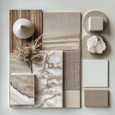 various materials are arranged on a white surface, including marbles and stoneware in different colors