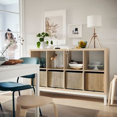 a dining room table with chairs and baskets on it