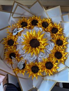 a bunch of flowers that are on top of some paper and one is made to look like sunflowers