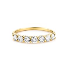 a yellow gold ring with five diamonds