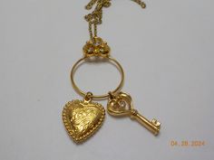 Vintage key to my heart pendant necklace. 25" gold tone chain with spring ring fastener. Pendant is 2 1/2"L, 1"W. Gold tone heart reads "Love". Key has a clear rhinestone at the top. Gorgeous!! Excellent condition. Vintage Gold Jewelry With Keys, Vintage Gold Key Necklace, Vintage Gold Necklaces With Keys, Vintage Key, Vintage Keys, Key To My Heart, Heart Pendant Necklace, Clear Rhinestones, Spring Rings