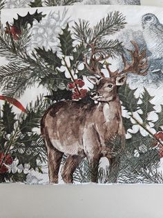 a deer with antlers on it's back standing in front of a christmas tree