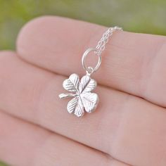 "Sterling Silver Four Leaf Clover A simple and elegant sterling silver Four Leaf Clover, a perfect lucky charm to wear during the day. We hand make these in our studio, then we attach a sterling jump ring to act as bail. The pendant includes a sterling silver curb chain. The Clover Charm is about 1/2 of an inch in length. You can choose the chain length - 16,18 or 20 inches. Are you new to Etsy? Shop my store and add your favorite items from The Jewelry Girls to your cart. Most of my items can b Dainty Round Pendant Charm Necklace For Good Luck, Dainty Flower Pendant Charm Necklace For Good Luck, Dainty Good Luck Flower Pendant Charm Necklace, Dainty Charm Necklace Gift, Dainty Silver Charm Necklace Stamped 925, Delicate Sterling Silver Charm Necklaces, Delicate Sterling Silver Charm Necklace, Dainty Sterling Silver Hypoallergenic Charm Necklace, Delicate Engraved Sterling Silver Charm Necklace