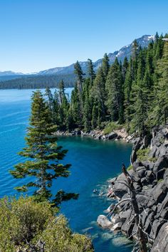 a lake surrounded by trees and rocks