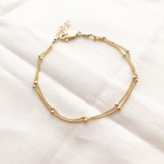 A perfect everyday dainty satellite bracelet.You can choose from 2-3 strands on a single bracelet. wear it by itself, or stack it with others. It makes the PERFECT gift for yourself or someone awesome! Wear your jewelry all day and night, even when washing your hands! We recommend cleaning your pieces once a week to keep them in great condition. Item Details:• This listing is for ONE(1) Layered satellite bracelet.• This bracelet comes with an adjustable extender for that perfect fit.• Length is Delicate Chain Bracelet With Extender, Minimalist Multi-strand Satellite Chain Jewelry, Delicate Gold Bracelet With Satellite Chain, Elegant Sterling Silver Bracelet With Extender For Everyday, Dainty Double Chain Everyday Jewelry, Dainty Sterling Silver Adjustable Bracelet For Everyday, Delicate Sterling Silver Bracelet With Adjustable Chain, Dainty Adjustable Sterling Silver Bracelet For Everyday, Adjustable Dainty Sterling Silver Bracelet For Everyday