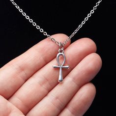 "This Silver Ankh Necklace is made of high-quality components - the American-made strong silver-plated steel chain and the beautiful, expensive-looking fine silver-plated Ankh pendant, finished with a larger lobster clasp for your convenience. It will be a pleasure to wear and see. You can easily customize this necklace by choosing different chain lengths and adding an initial letter charm or a dangling birthstone. The available chain length - 14\", 16\", 18\", 20\", 22\", 24\" The pendant size: 21 mm in height, 10 mm wide Swarovski Crystal Birthstone: 6 mm in diameter + EXTRA INITIAL CHARMS: https://www.etsy.com/ca/listing/1184047580 + DANGLING BIRTHSTONES: https://www.etsy.com/ca/listing/646857292 For more of the Egypt theme jewelry: https://www.etsy.com/ca/shop/LeafOnWaterStudio?search_ Egyptian Cross, Symbol Jewelry, Ankh Pendant, Ankh Necklace, Egyptian Symbols, Symbolic Jewelry, Letter Charm, Letter Charms, Initial Letter