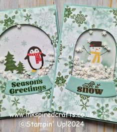 two snow globes with penguins and trees on them, one is for season's greetings