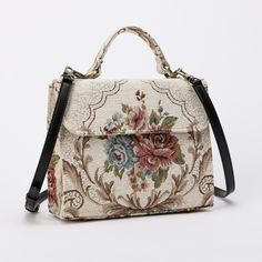 With a nod to the Victorian era, MCW's freshly combines the classic and elegant design of the traditional carpet satchel with a textural and tactile twist. This exquisite top handle satchel is a perfect blend of style and practicality. Spacious interior with zipper and slip pockets, detachable shoulder strap. Sturdy exterior in carpet or velvet, cotton lining. Convenient magnetic flap closure, brass feet for stability. Features: * Detachable, adjustable shoulder strap * Magnetic flap for easy access * Interior slip and zipper pockets * Hand-polished brass hardware * Includes dust bag Dimensions: * Satchel size: 9.50"W x 4"D x 8"H * Adjustable shoulder strap: 43.50" to 51.15" Interior Pockets: * Zipper pocket: 7"W x 5"H * Slip pocket: 8"W x 5.50"H Weight: 1lb 5oz Traditional Carpet, Secret Sale, Weekend Getaway, Victorian Era, Easy Access, Purses And Handbags, Top Handle, Elegant Design, Shoulder Bags