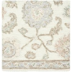 a white rug with an ornate design on the front and back side, in various colors