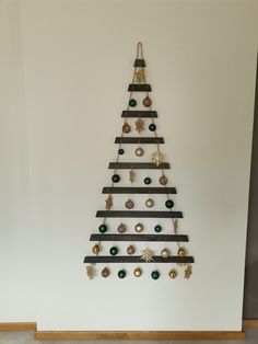 a christmas tree made out of black and white strips with ornaments hanging from the top