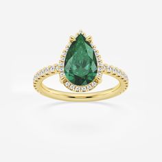 a rose gold ring with a pear shaped green stone surrounded by small white and pink diamonds