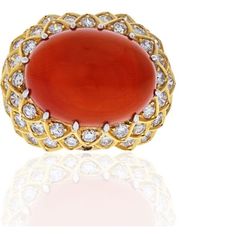 Capture the essence of timeless elegance with the David Webb Platinum & 18K Yellow Gold Oval Coral And Diamond 1970's Ring. This exquisite piece of jewelry carries with it a rich history, making it a cherished heirloom for those who appreciate the allure of vintage glamour.Crafted by the renowned jewelry designer David Webb during the 1970s, this ring showcases his signature style that captivated the world's elite. Webb's creations were a well-kept secret, adorning the fingers of the rich and fa Rich And Famous, Emerald Cut Diamond Ring, David Webb, Coral Ring, The David, Coral Jewelry, Oval Rings, Vintage Glamour, Emerald Cut Diamonds