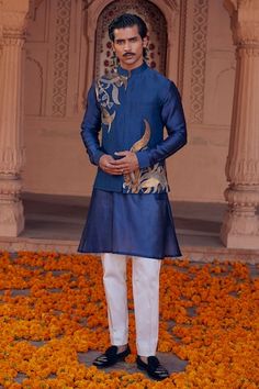 Blue chanderi bundi with placement abstract pattern and contrast metallic sequin embroidery. Paired with full sleeve kurta and contrast straight pyjama. - Aza Fashions Designer Bandhgala With Gold Embroidery In Chanderi, Blue Bandhgala With Mirror Work For Festive Occasions, Designer Blue Sherwani With Gota Work, Blue Bollywood Sherwani With Gota Work, Blue Bandhgala For Navratri Designer Wear, Blue Chanderi Nehru Jacket For Designer Wear, Festive Chanderi Bandhgala With Gold Embroidery, Festive Bandhgala With Gold Embroidery Chanderi, Blue Kurta With Gold Embroidery For Diwali