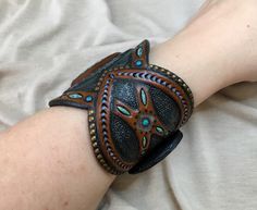 Handmade Black Artisan Leather Bracelet, Handmade Artisan Black Leather Bracelet, Adjustable Concho Cuff Bracelet Gift, Brown Southwestern Jewelry With Patina, Southwestern Brown Jewelry With Patina, Handmade Turquoise Wearable Art Jewelry, Bohemian Turquoise Hand Painted Jewelry, Turquoise Bohemian Hand Painted Jewelry, Hand Painted Bohemian Bangle Jewelry