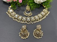 pearl  kundan set with tikka set.  lightweight earrings  Style tip- ----------- Pair it with any beautiful traditional outfits  and flaunt with Unique style of collection from us. Perfect match for Festival and Traditional wear.  Take Care Tips-  ---------------- Kee away from perfume, Hair spray and. Moisture.  Store in dry place , Ziplock bag or Airtight box.    Clean with dry cloth.  Jewellery is the last thing you should wear and first thing you should remove.  ------------------------------ Festive Jewelry Sets With Mirror Work As Gifts, Festive Mirror Work Jewelry, Festival Jewelry Sets With Mirror Work For Gifts, Festive Jewelry With Mirror Work As Gift, Bohemian Kundan Jewelry For Eid, Gold Jewelry With Mirror Work For Gift, Stone Work Jewelry For Eid, Round Jewelry For Eid Party, Kundan Jewelry With Mirror Work For Gift