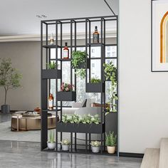 a living room filled with lots of plants next to a wall mounted planter in the corner