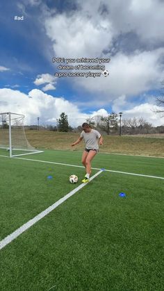 a woman kicking a soccer ball on top of a field