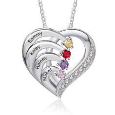 three hearts with names engraved on the side and two different colored stones in the middle