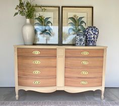 two vases are sitting on top of a dresser