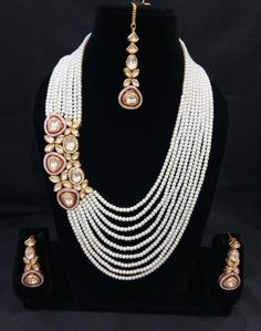 The base metal color is Gold tone studded with white kundan stone . This jewellery set consists of a necklace and a matching pair of earrings and a mangtika Off-white gold-plated beaded and kundan-studded layered necklace, secured with drawstring closure A pair of matching drop earrings, secured with a post and back closure White Kundan Jewelry Sets As Gift, White Chandbali Bridal Sets Gift, White Meenakari Pearl Necklace In Temple Jewelry Style, White Pearl Necklace With Meenakari For Temple, White Meenakari Pearl Necklace For Temple Jewelry, White Temple Jewelry Bridal Sets For Festivals, White Stone Work Necklace For Reception, White Stone Work Necklaces For Reception, White Tilla Bridal Necklace For Diwali