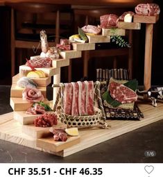 a wooden table topped with different types of meat