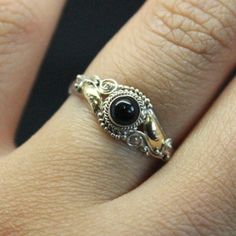 This is a vintage Sterling Silver 925 ring with 14k Yellow Gold plated detail. Set center is a Black Onyx stone. Available in sizes 4, 5, 6,7 Victorian Black Sterling Silver Rings, Victorian Style Black Sterling Silver Rings, Black Sterling Silver Vintage Rings, Antique Black Sterling Silver Rings, Vintage Black Gemstone Rings, Vintage Black Sterling Silver Rings, Black Heirloom Sterling Silver Ring, Vintage Black Round Rings, Handmade Vintage Onyx Rings