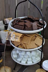 a three tiered tray filled with chocolate and marshmallows