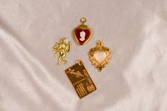 The Lovers Vintage Charm Lot includes: 1 Vintage Red Cameo Heart Locket Charm, 1 Vintage I Love You Postcard Charm, 1 Vintage Pearl Heart Charm, and 1 Vintage Cupid Charm. All charms are brass and may need to be touched up with a jewelry cloth to keep them sparkling! Not to worry I include a jewelry cloth with every order BUILD YOUR OWN CUSTOM CHARM NECKLACE here: https://cloakedinconfidence.etsy.com/listing/1660083621 This charm comes with a gold filled jump ring ready to slide on any chain you might have or to use for jewelry making projects♡ If you need a chain please check out my gold filled everyday paperclip chain: https://www.cloakedinconfidence.co/product-page/large-paperclip-chain This listing is for all brass charms included in the picture. These charms are all light weight and e Valentine's Day Vintage Charm Necklaces, Vintage Charm Necklace With Heart Charm For Anniversary, Vintage Heart Charm Necklace For Keepsake, Vintage Heart Charm Necklaces For Valentine's Day, Vintage Charm Necklaces For Anniversary On Valentine's Day, Vintage Heart-shaped Keepsake Charm Necklace, Vintage Heart Pendant Charm Necklace For Valentine's Day, Vintage Heart Pendant Charm Necklace For Wedding, Vintage Heart Pendant Charm Necklace