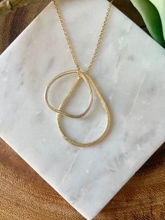 "Looking for a simple, but beautiful geometric necklace that is great for layering? Here it is! This handmade necklace is made from a triangular shaped charm and a teardrop shaped charm strung through a delicate chain. The photos show this necklace at 24\", but custom lengths are always welcome! This unique necklace is perfect for anyone loves accessorizing with on trend, modern or minimalist jewelry. Made from high quality 16k gold plated brass. It has an effortless chic vibe to it and is great Modern Everyday Teardrop Pendant Necklace, Modern Teardrop Pendant Necklace For Everyday, Modern Teardrop Pendant Necklace With Delicate Chain, Minimalist Teardrop Chain Necklace With Adjustable Chain, Modern Gold Necklace With Teardrop Pendant, Modern Gold Teardrop Pendant Necklace, Minimalist Drop Necklace For Layering, Minimalist Teardrop Pendant Charm Necklace With Adjustable Chain, Minimalist Teardrop Pendant Necklace With Adjustable Chain