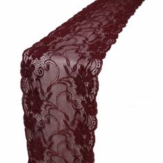 a red lace table runner on a white background