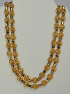 Alfred Philippe was Crown Trifari's Chief Designer from 1930 until 1968.  This exquisite necklace and earrings set was introduced during that time period and became referred to simply as the "Electra Collection".  The collection pieces utilized two innovative and striking types of beads.  The first type was the so called "Trifanium" spiked bead.  The second type was a gold plated crystal called an "Autrum" bead.  The intent of the Electra design was simply to "blow away" the competition--which i Formal Gold Beads Jewelry, Gold Double Strand Wedding Jewelry, Double Strand Gold Wedding Jewelry, Double Strand Gold Jewelry For Wedding, Yellow Gold Double Strand Jewelry For Wedding, Antique 22k Gold Jewelry For Anniversary, Vintage Double Strand Jewelry For Formal Occasions, Gold Double Strand Jewelry For Festive Occasions, Vintage 22k Gold Jewelry For Anniversary