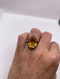 Unusual cut of citrine and surrounded by red garnets in golden 925 sterling silver setting Handmade Size 6.5 Can be resized, my jeweler charges $20 All rings are shipped in a nice gift box. Check out our over a THOUSAND great reviews!!! Engraving is $4 per letter and is not always perfect depending on the piece. It can take a few days if the jeweler is busy. This is payable to Paypal Judithsltd@gmail.com Luxury Citrine Gemstones For Gifts, Exquisite Topaz Ring With Gemstone Accents As Gift, Multi-stone Citrine Gemstone Ring, Oval Ruby Ring For Parties, Garnet Multi-stone Jewelry For Gifts, Oval Ruby Ring For Party, Multi-stone Citrine Gemstones, Gold Jewelry With Accent Stones For Parties, Gold Party Jewelry With Accent Stones