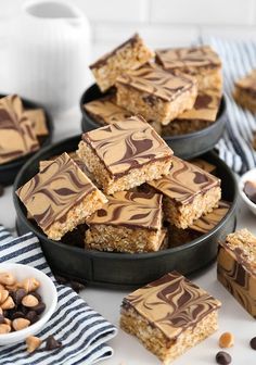 several pieces of chocolate peanut butter bars on plates