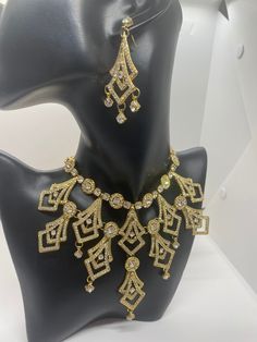 This is a beautifulAmerican diamond necklace set. This has cz stone work done with gold finish. This set gives the wear a modern look. Nice for evening events such as receptions. This set comes with a necklace, pair of earrings and a maang tikka(forehead piece hanging piece) Gold Bangle Set, Silver Choker Necklace, Bangles Indian, Indian Necklace, Diamond Necklace Set, Bollywood Jewelry, Silver Choker, Stone Work, American Diamond