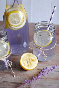 three mason jars filled with lemons and lavender water