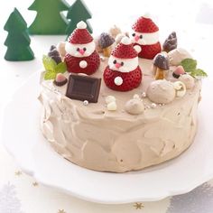 there is a cake decorated with santas and other decorations on the top of it