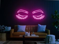 a living room filled with furniture and two large eyes on the wall above it's neon lights